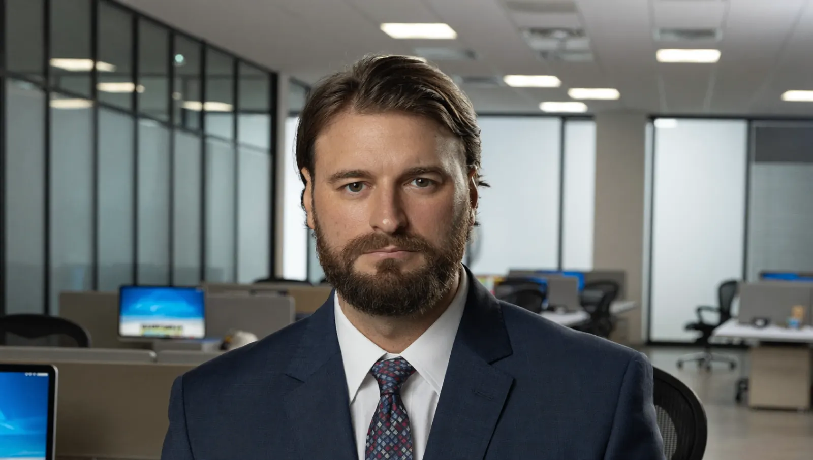 Alessio Vinassa in formal attire in an executive office setting